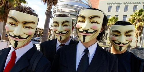 Group of men wearing masks in suits.